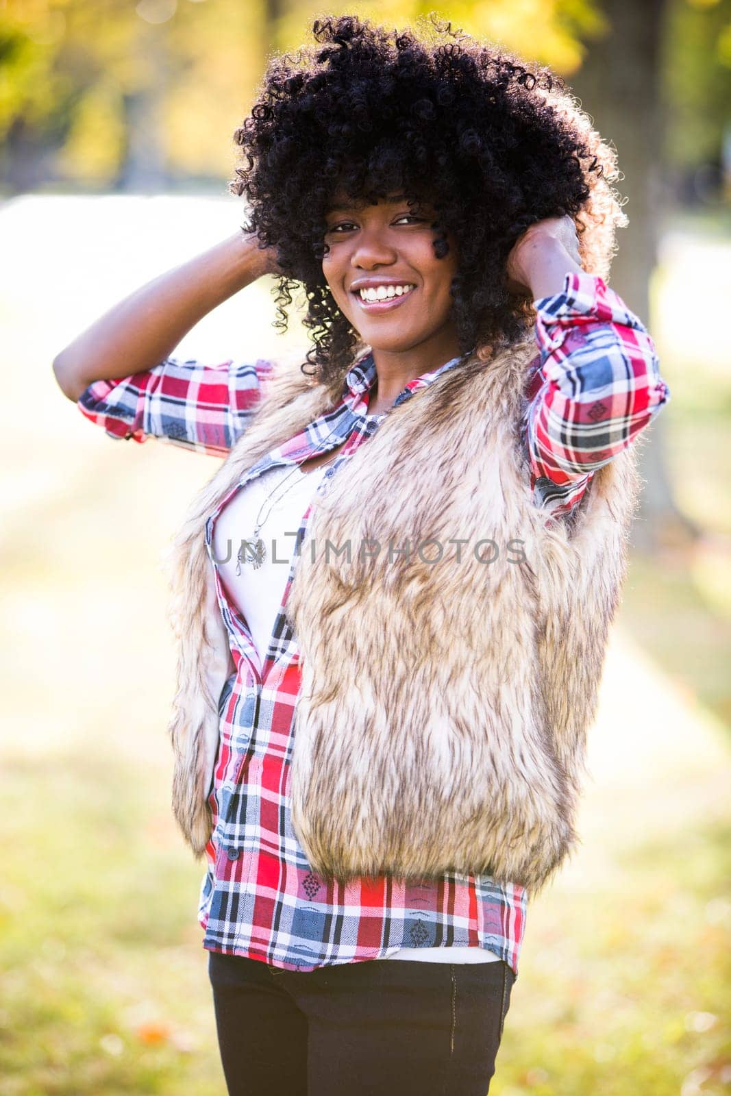 ethnic woman wearing fashion fall outfit outdoors int he park