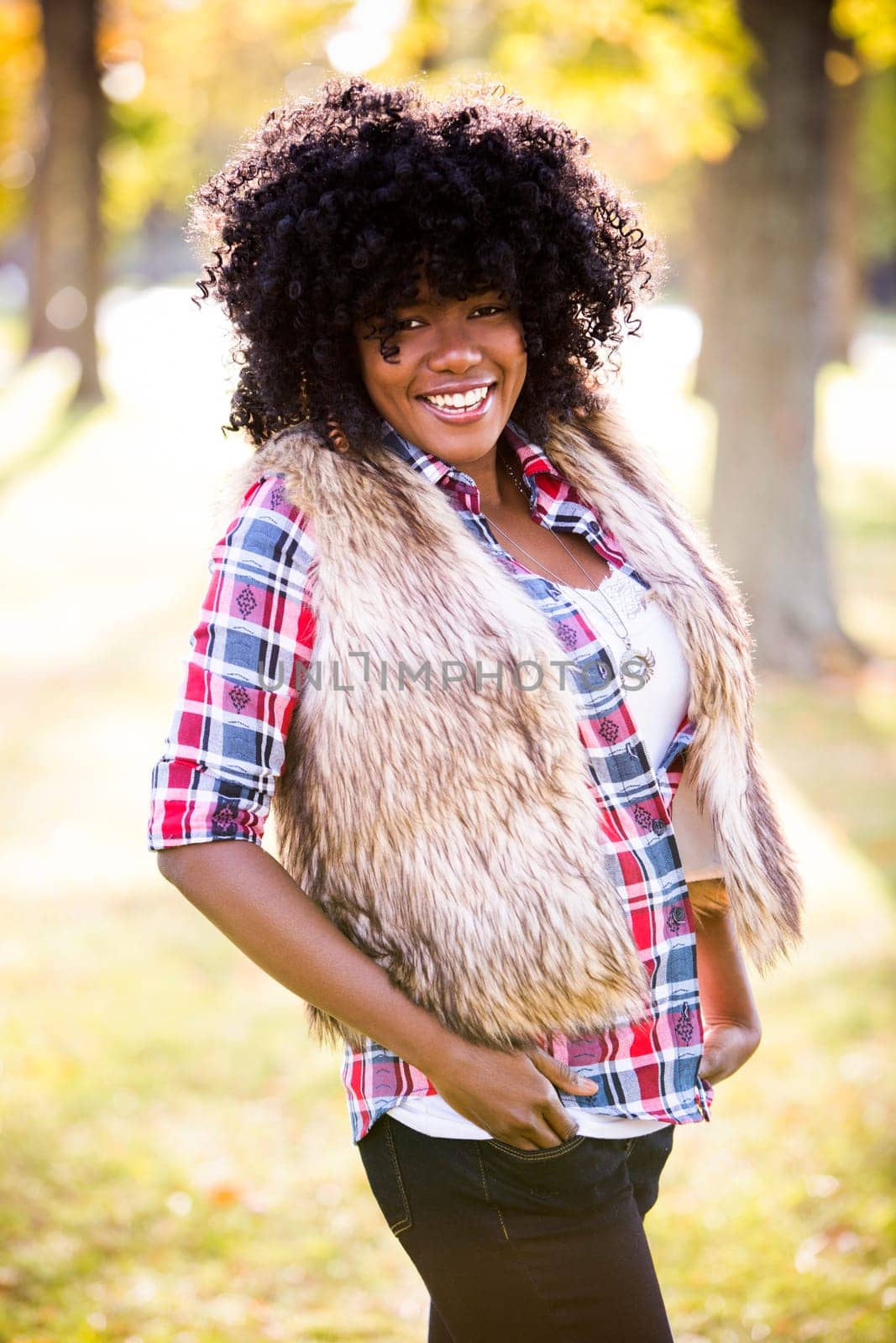 ethnic woman wearing fashion fall outfit outdoors int he park