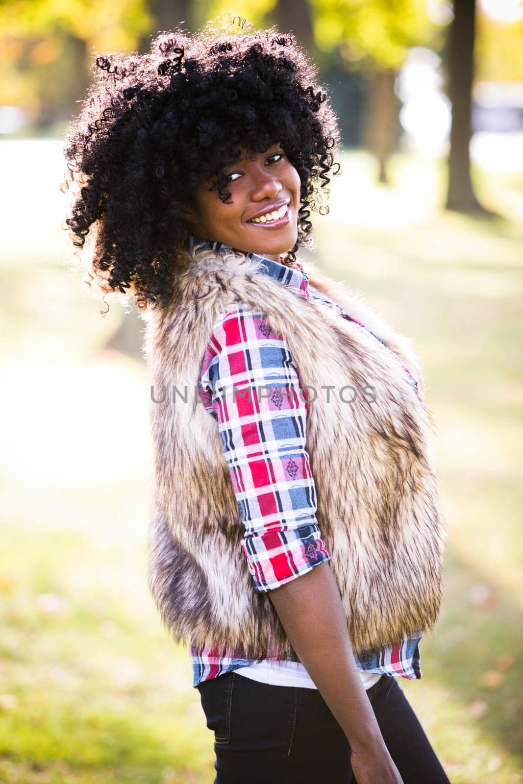 ethnic woman wearing fashion fall outfit outdoors int he park