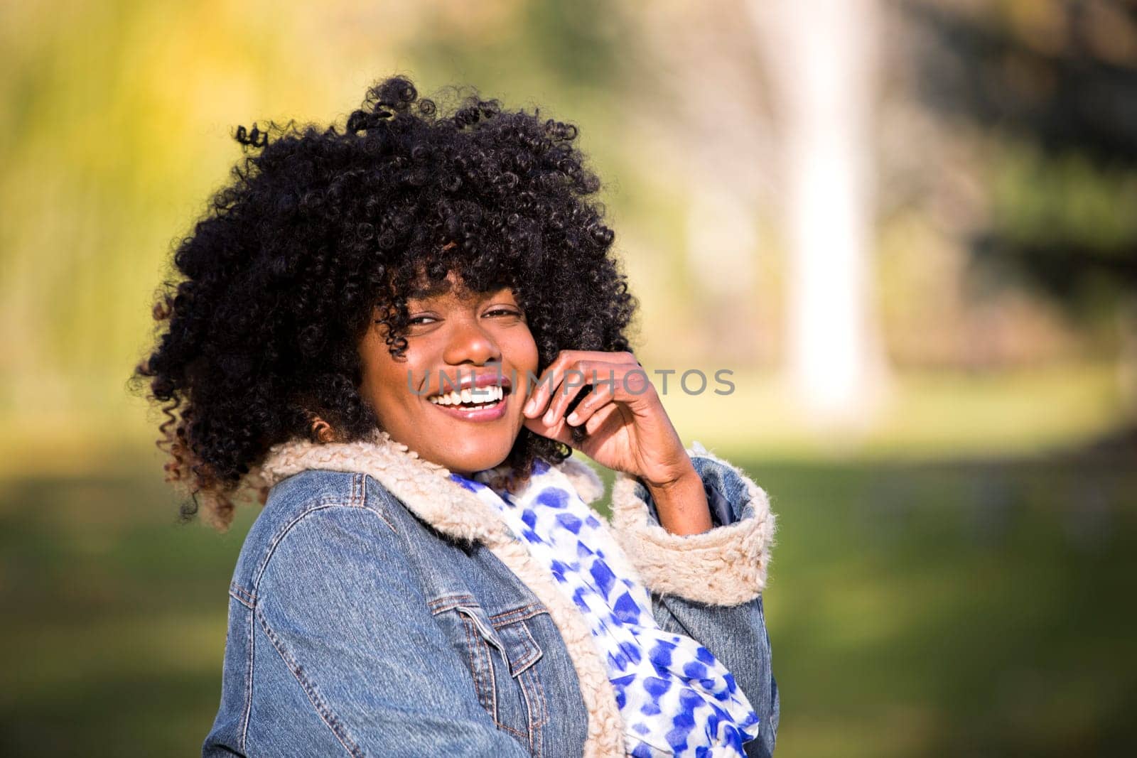 ethnic woman wearing fashion fall outfit outdoors int he park