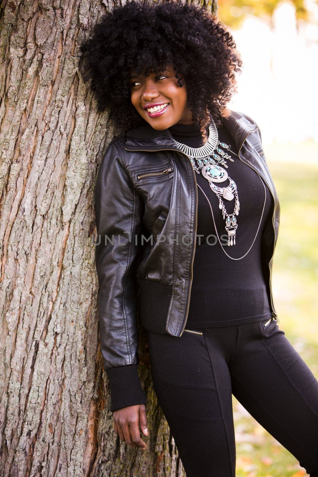 ethnic woman wearing fashion fall outfit outdoors int he park