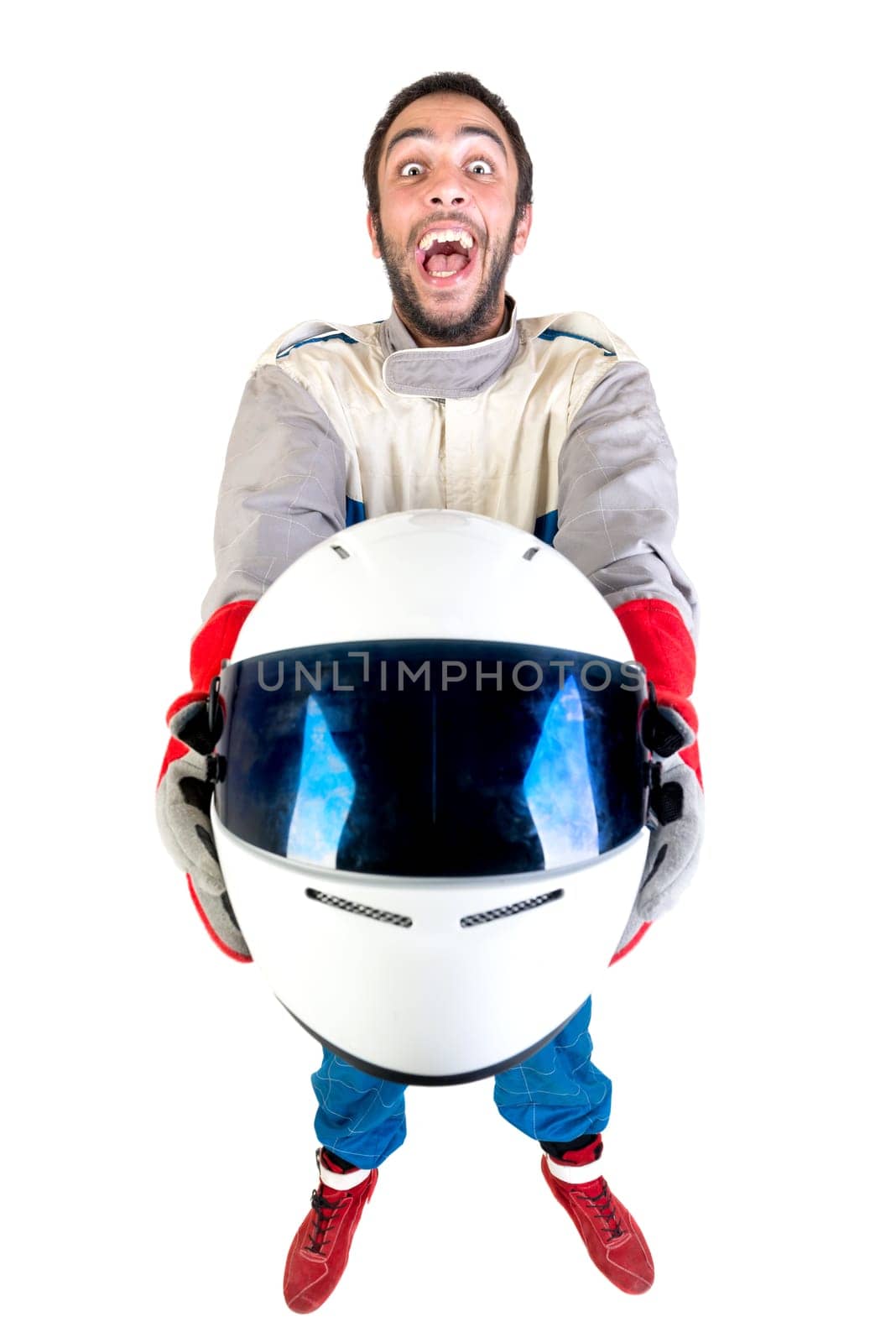 Racing driver posing with helmet isolated in white
