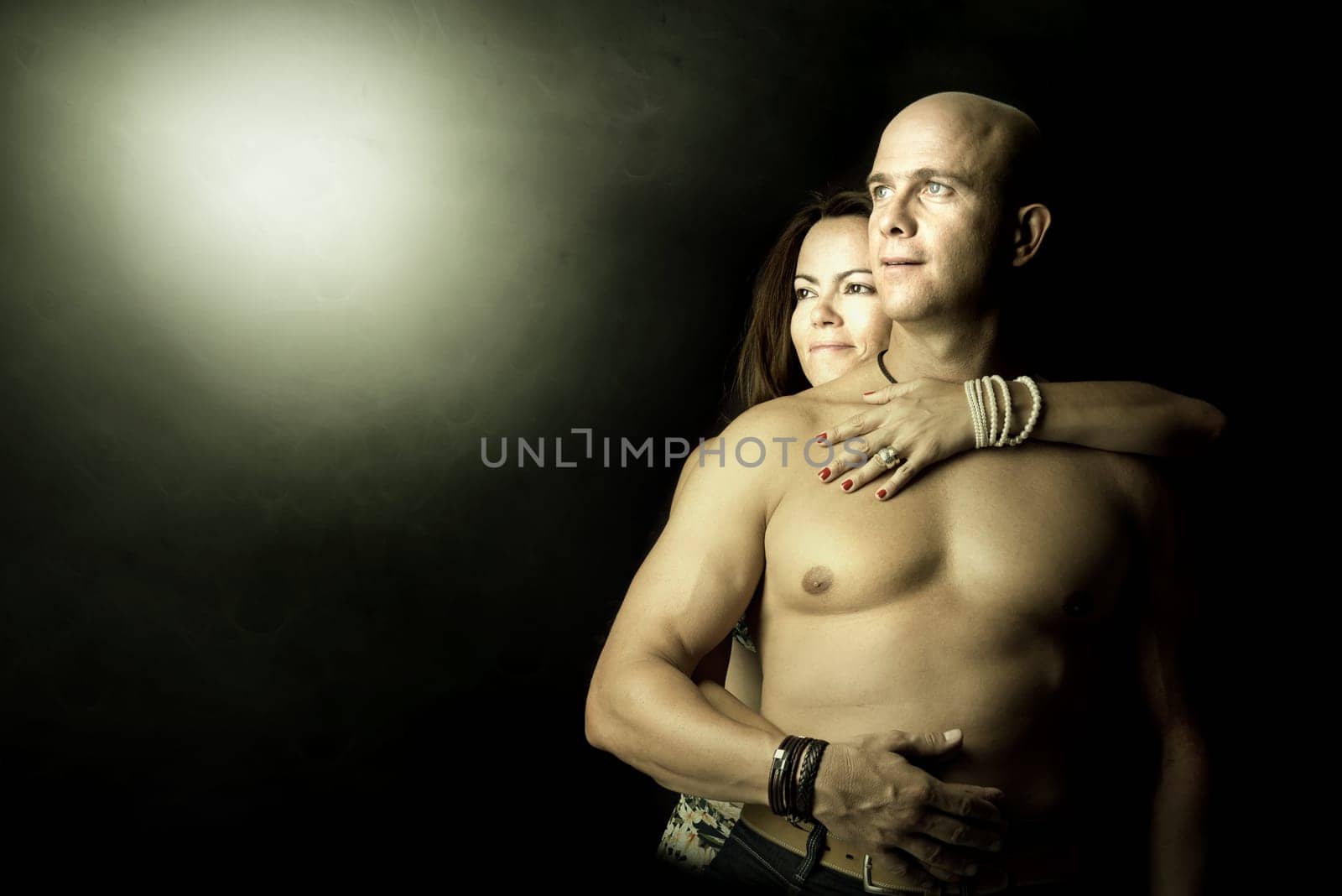 Sexy couple isolated in a black background