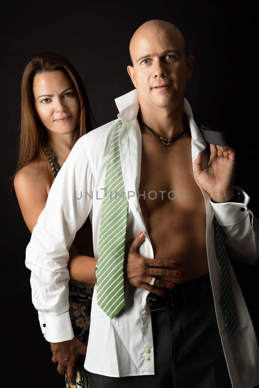 Sexy couple isolated in a black background