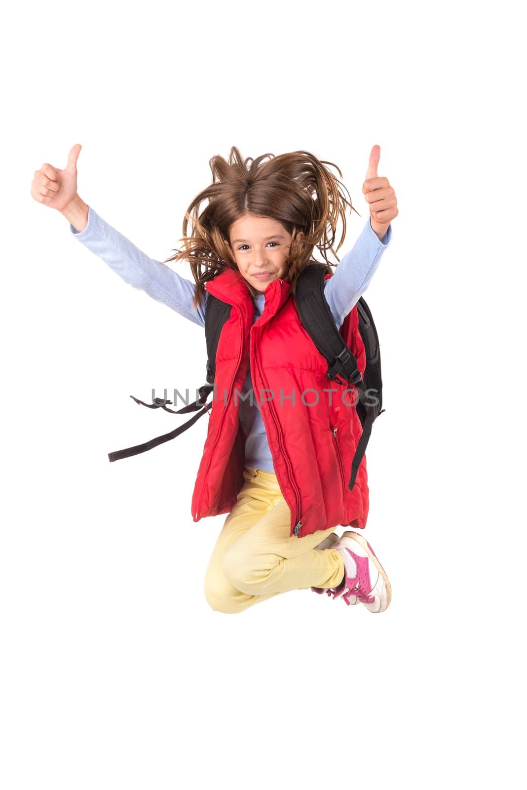 Young girl student jumping isolated in white