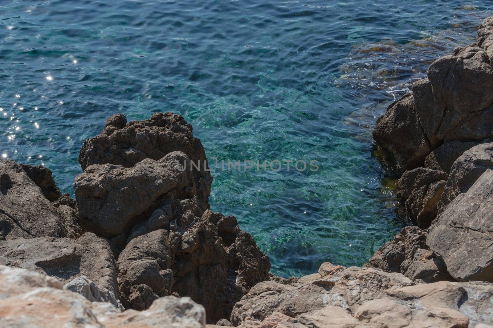 Small rock in the blue Mediterranean Sea on Mallorca's coast..