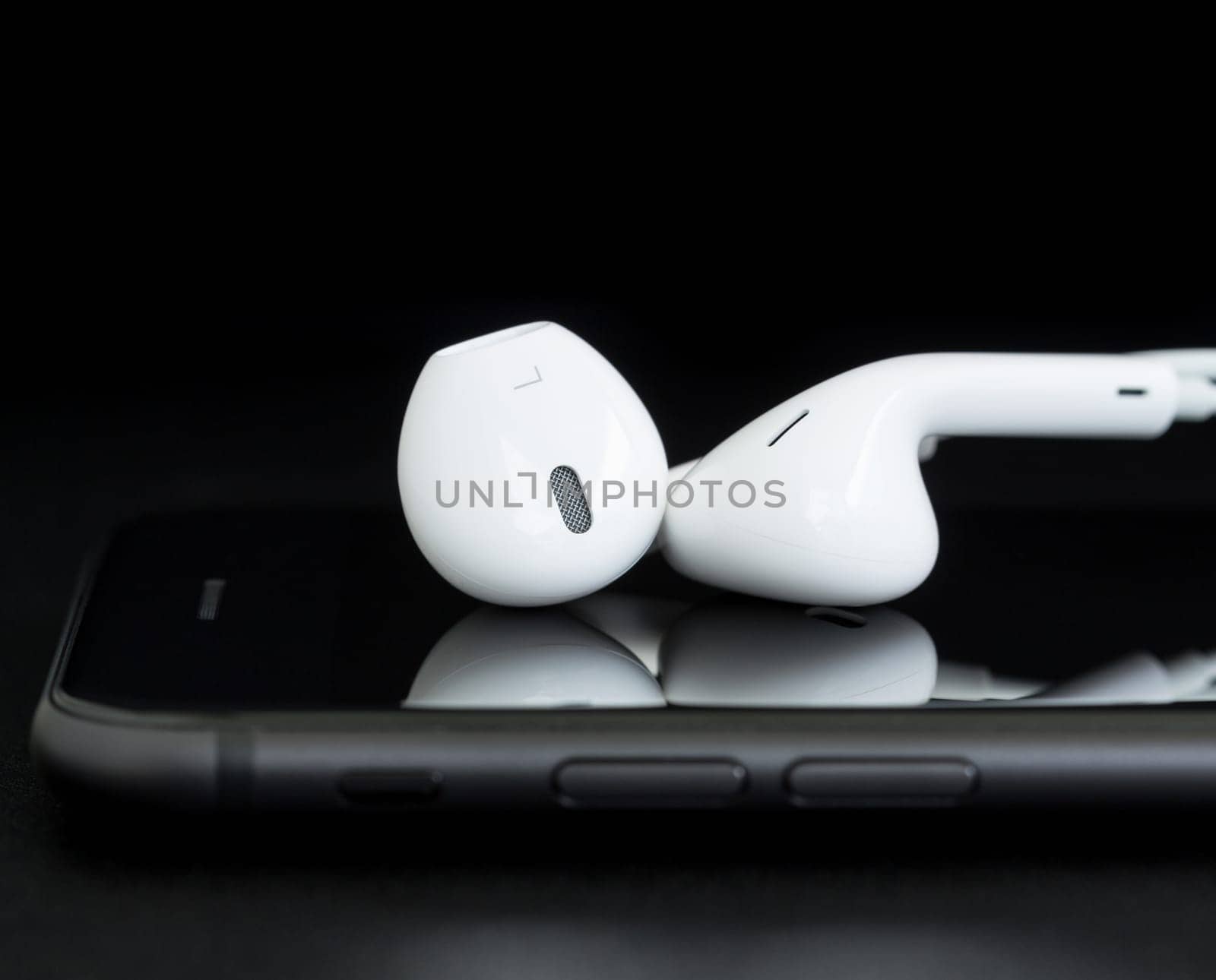 close-up headphone on phone black background