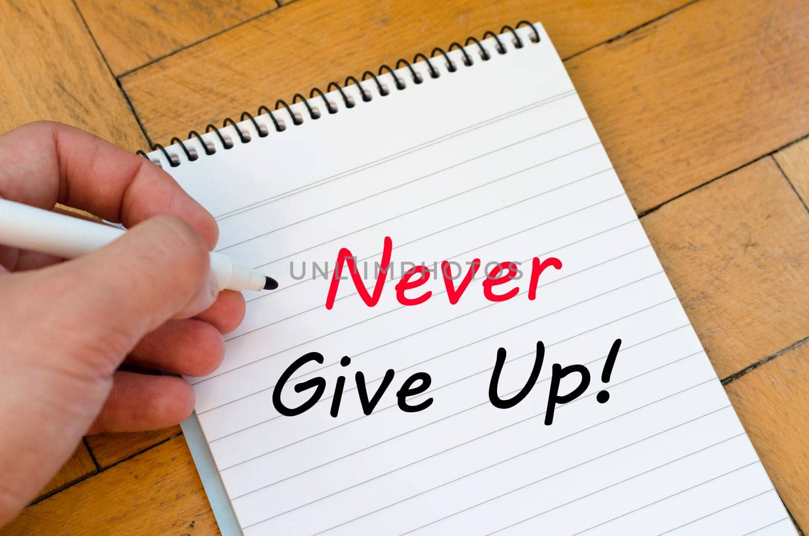 Never give up text concept write on notebook