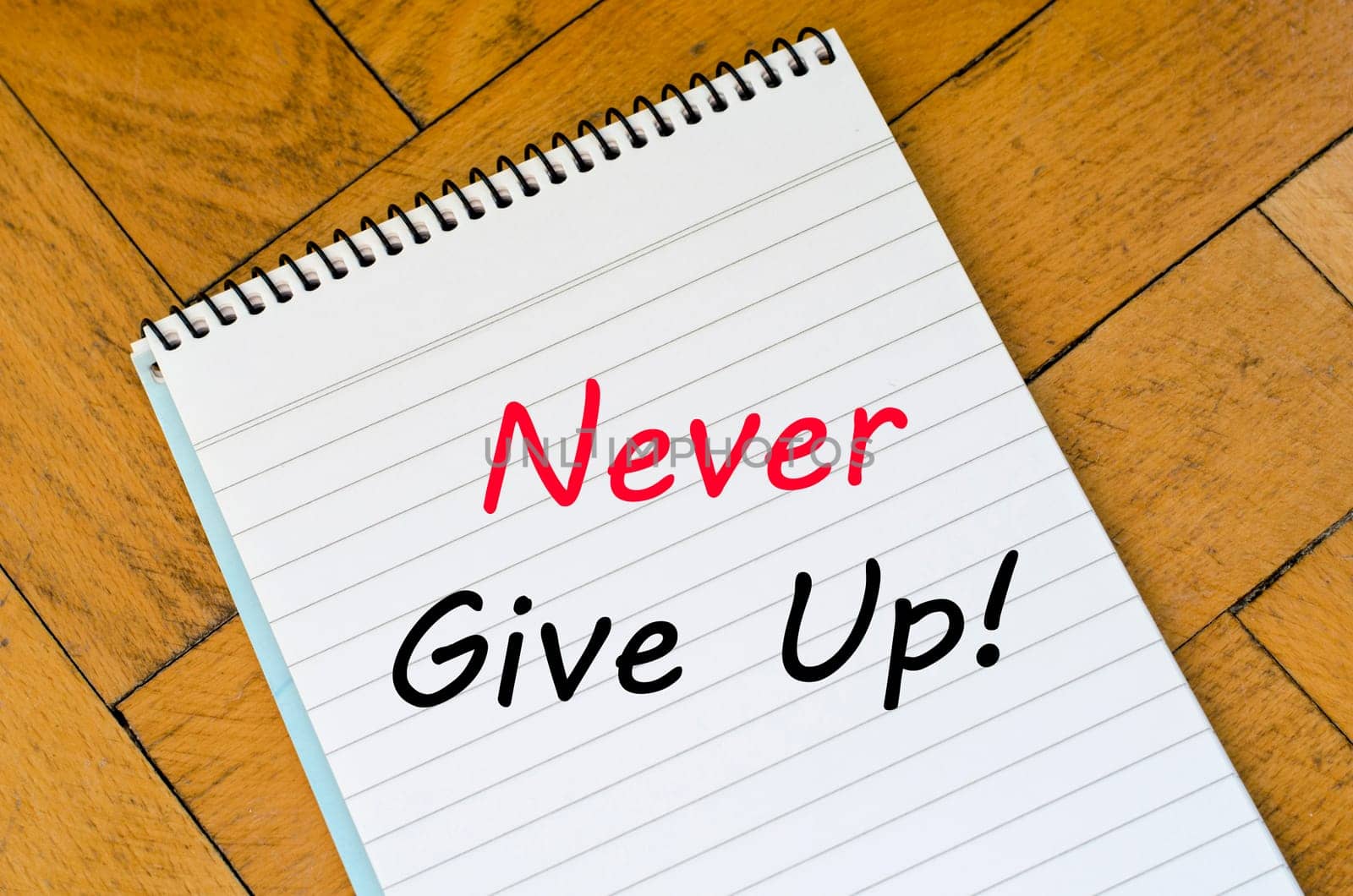 Never give up text concept write on notebook