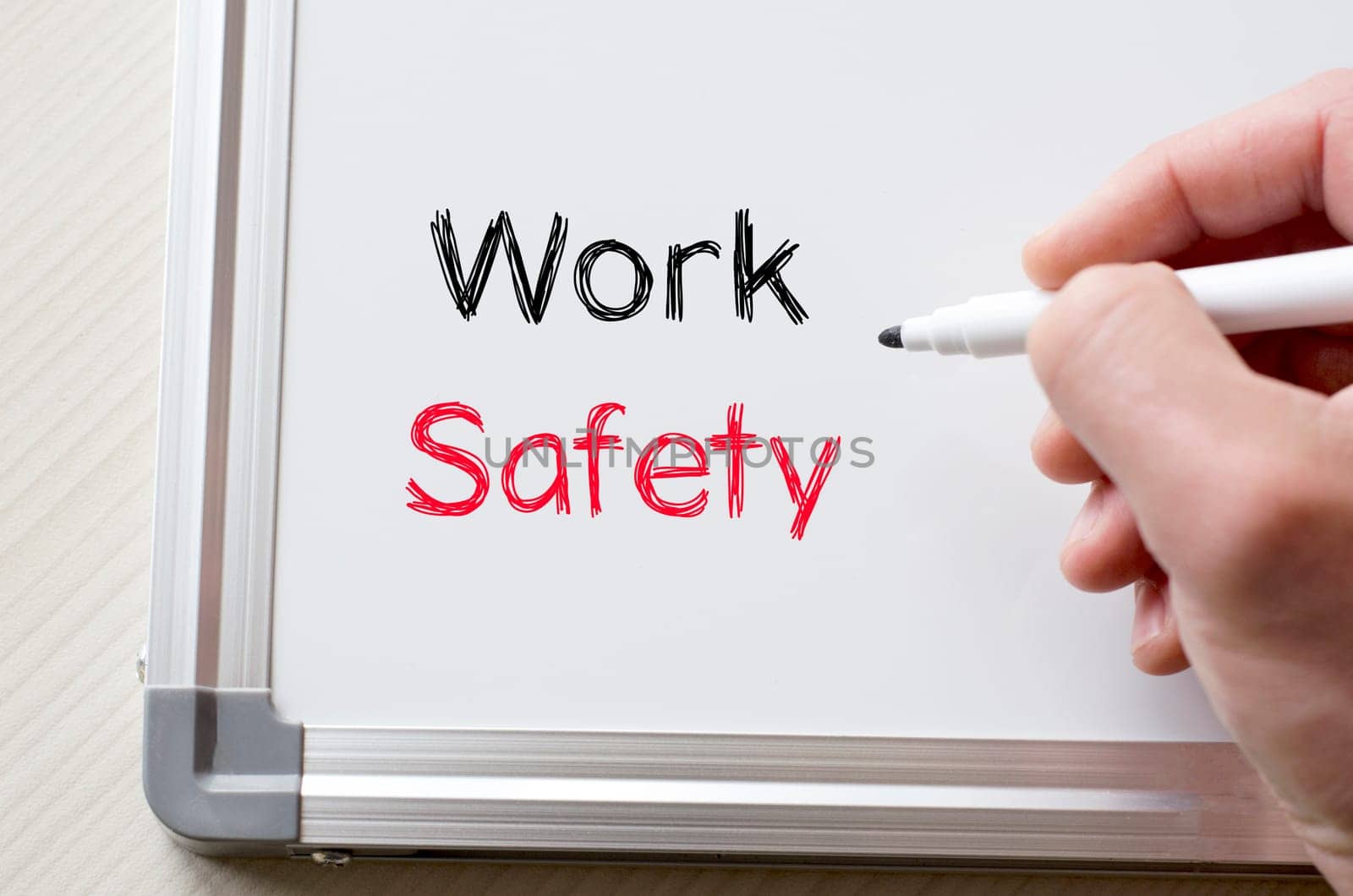 Human hand writing work safety on whiteboard