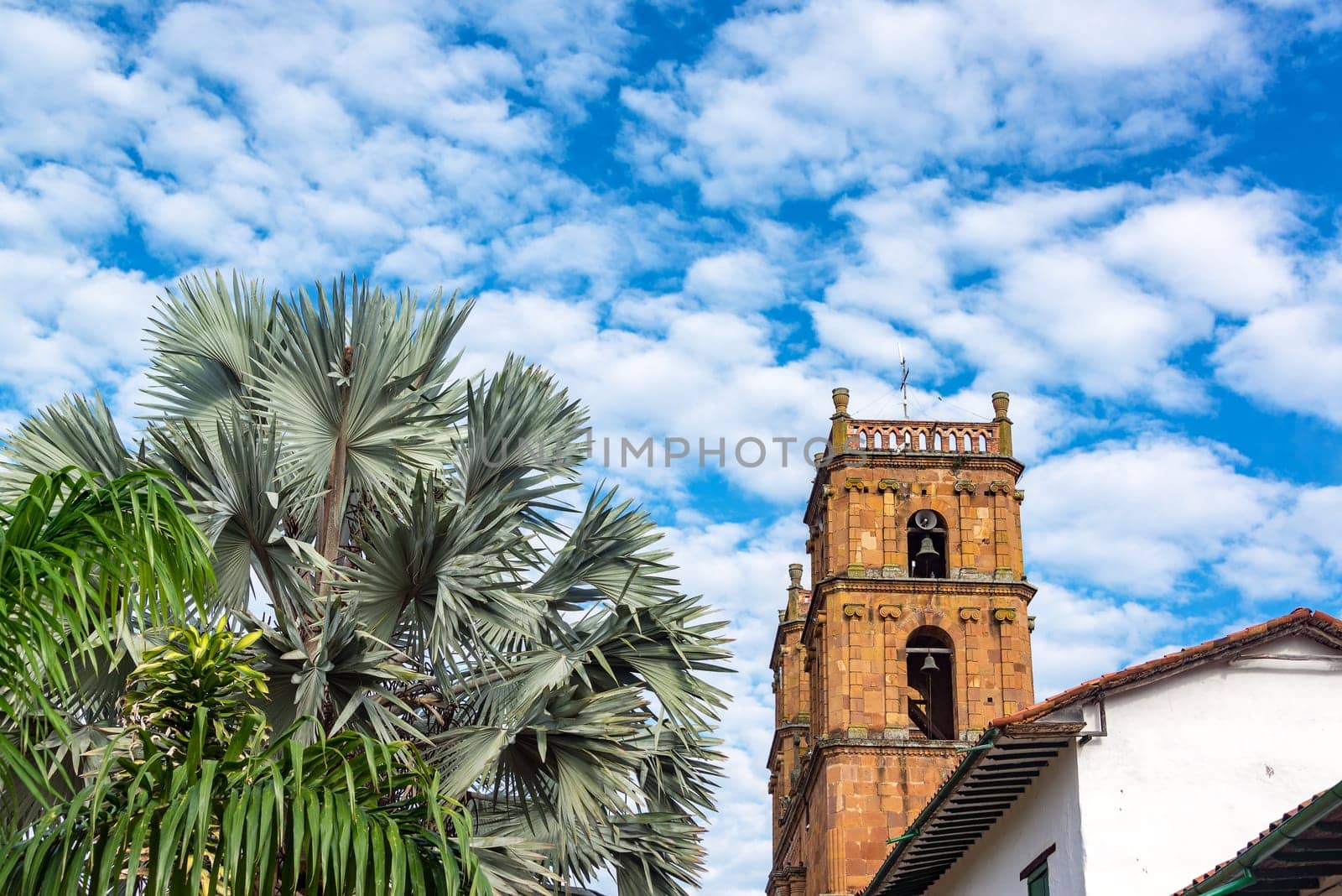 View looking up at the cathedral in Barichara, Colombia with an interesting sky and foliage