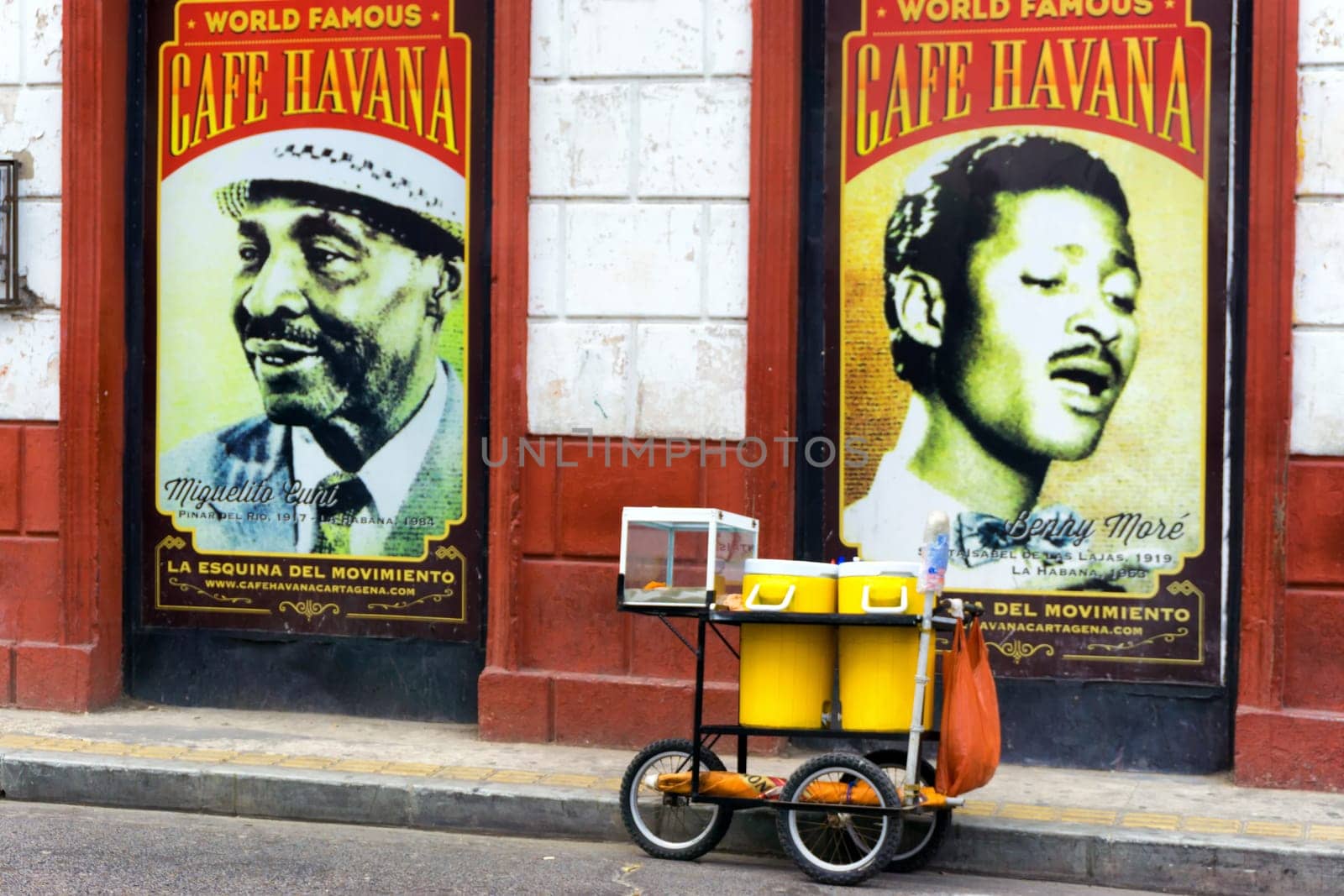 CARTAGENA, COLOMBIA - MAY 24: Food cart in front of posters for Cafe Havana, a bar known for live salsa music in Cartagena, Colombia on May 24, 2016
