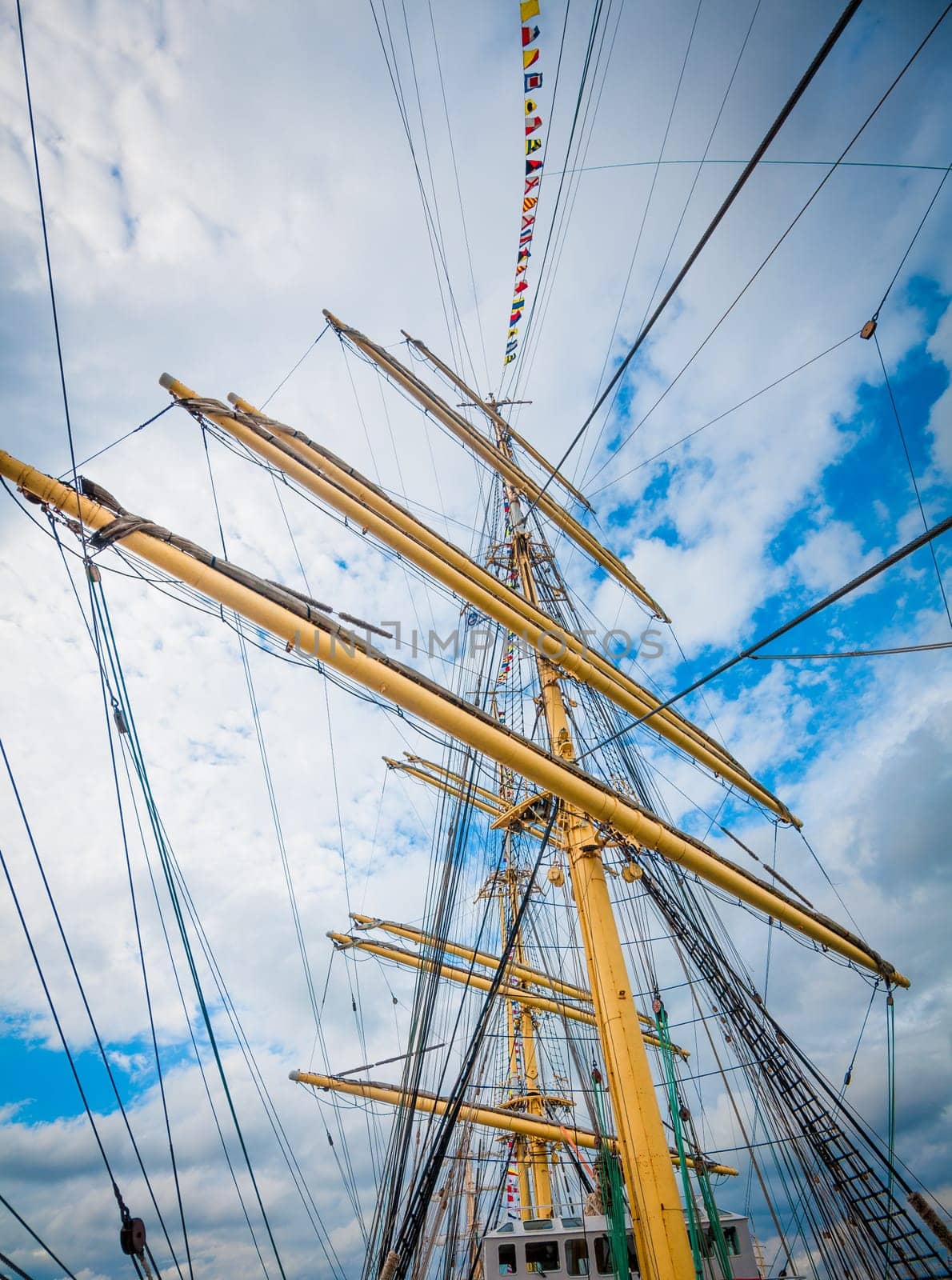Detail of a sailboat rigging.  Mast on traditional sailboats. Mast of large wooden ship.