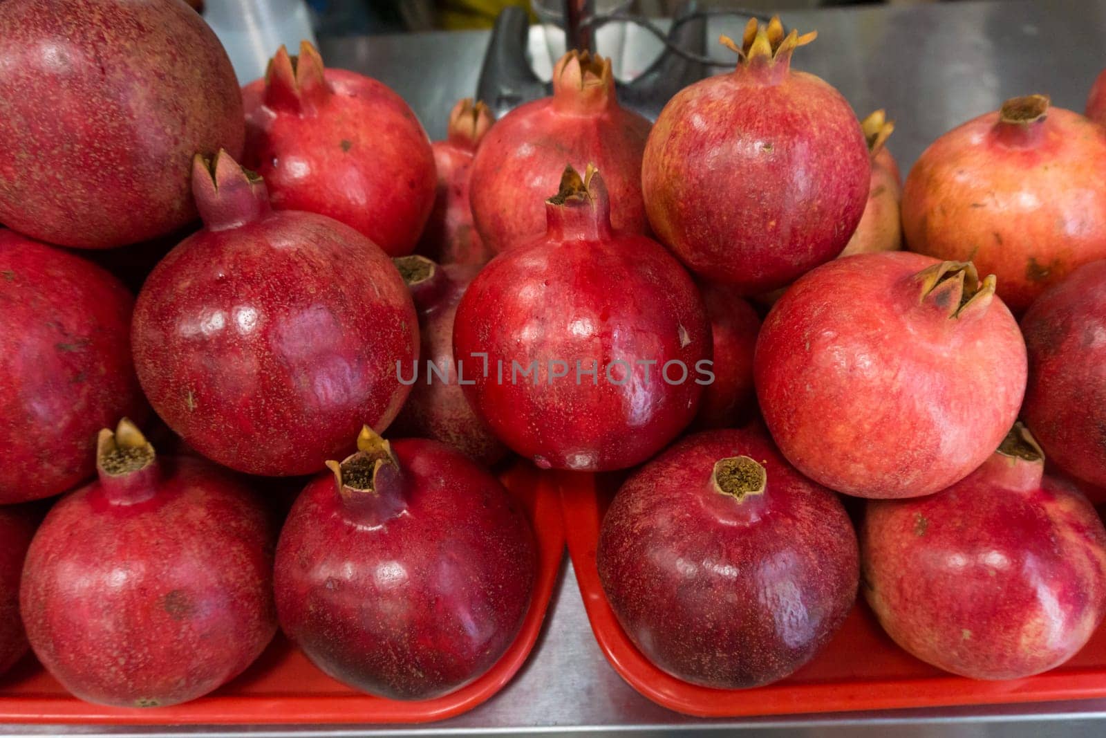 Pomegranates at the Market. Group of pomegranates. Pomegranate closeup, background