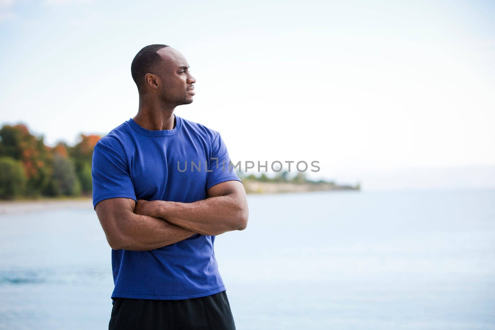 young black man wearing athletic wear on the beach