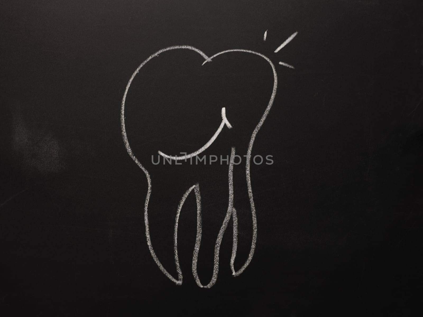 Hand drawn smiling tooth on a chalkboard, health care concept background