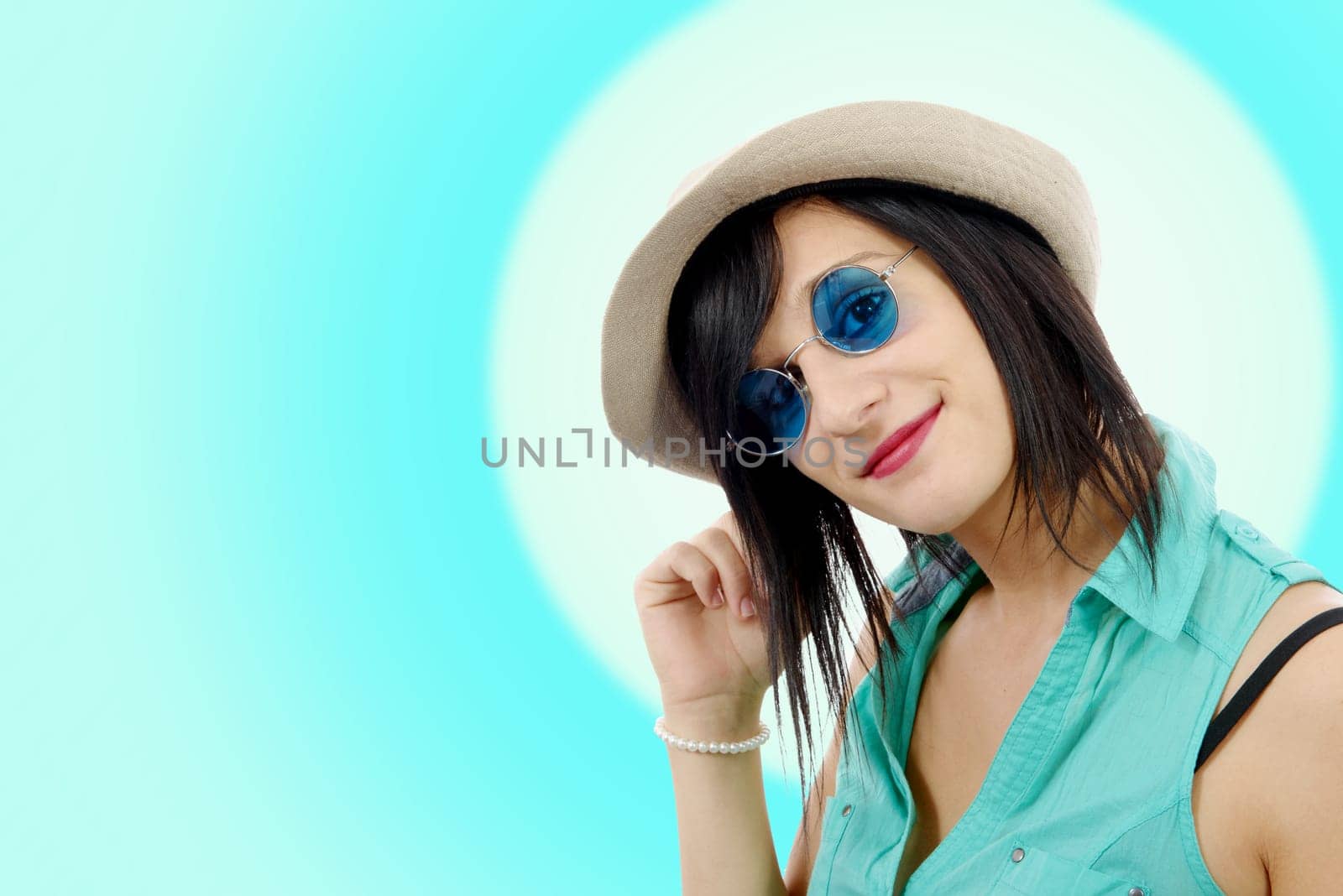 pretty young brunette woman with a summer hat and blue sunglasses