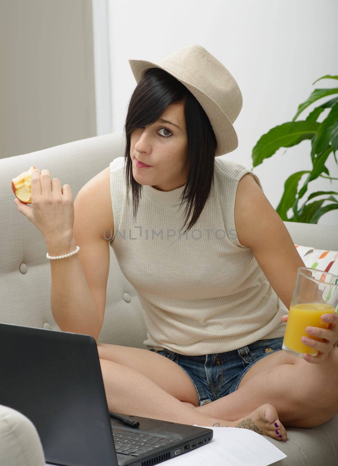 young student girl eating an apple in home