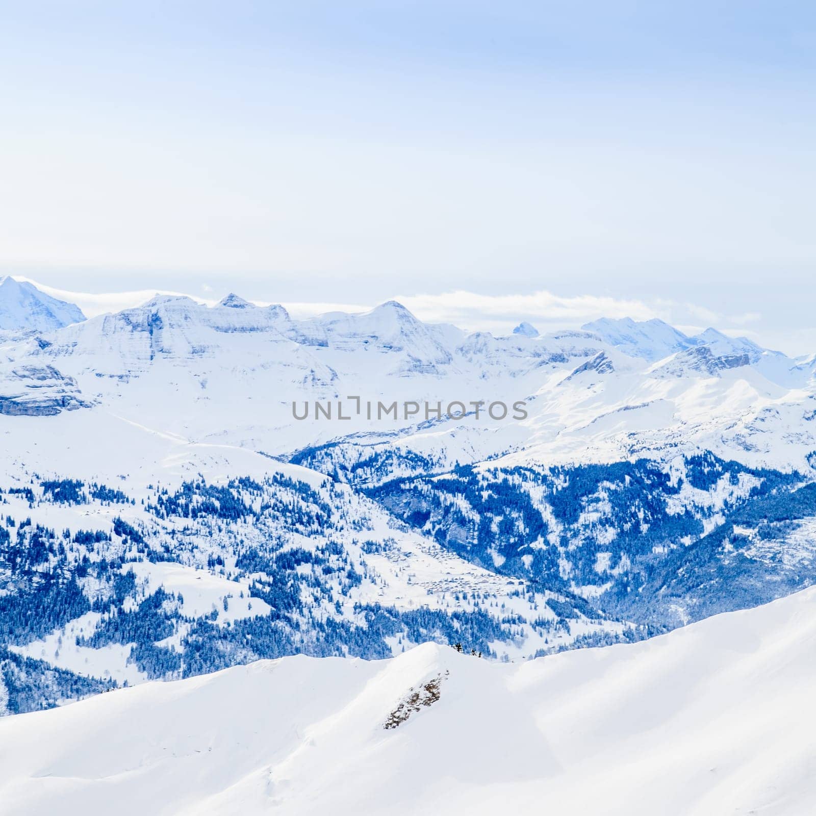 Winter snow covered mountain peaks in Europe. The Alps winter mountain landscape