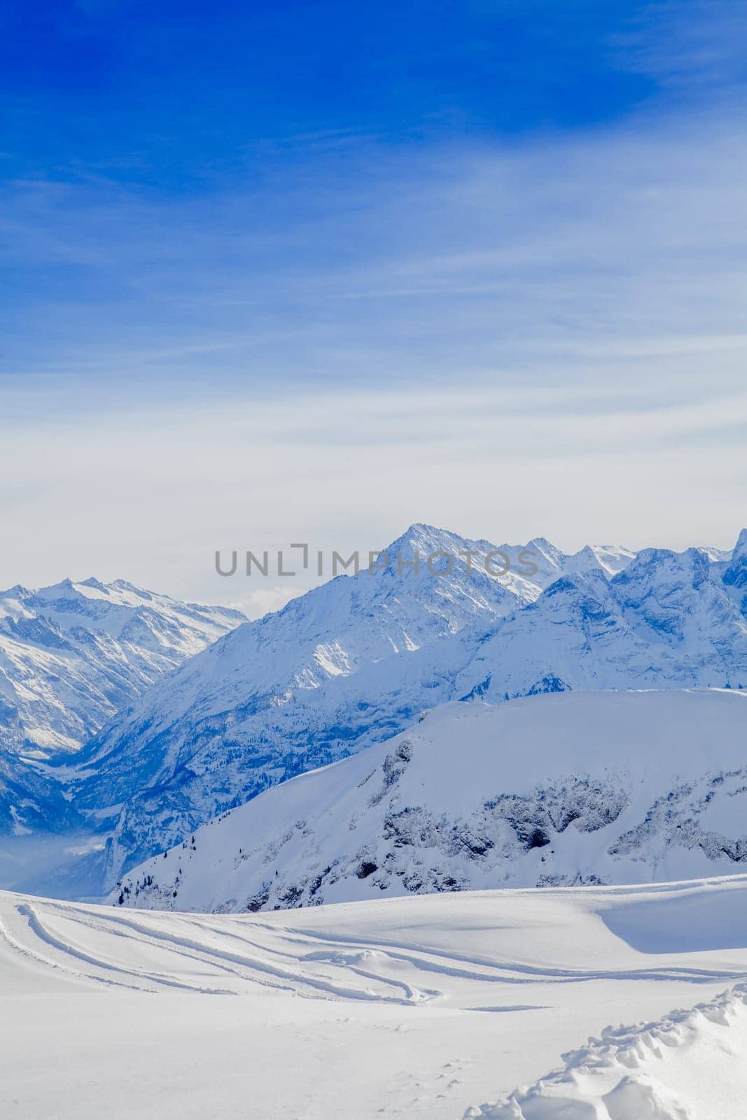 Winter snow covered mountain peaks in Europe. The Alps winter mountain landscape