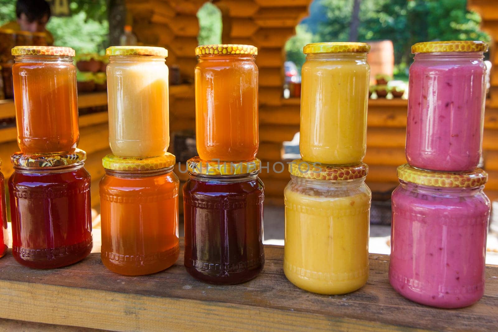 jars with honey on market.  Homemade honey. various jars of honey