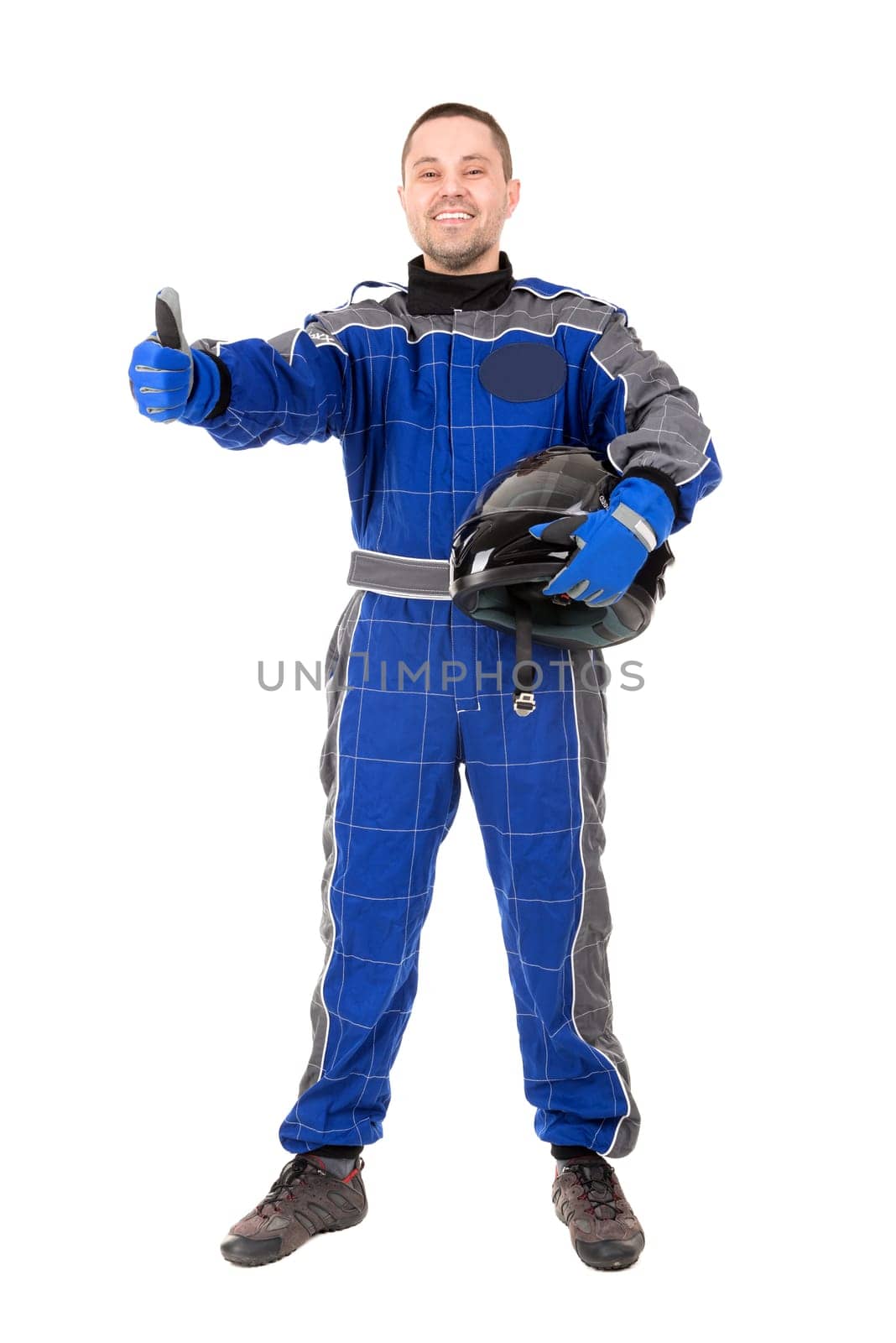 Racing driver posing with helmet isolated in white