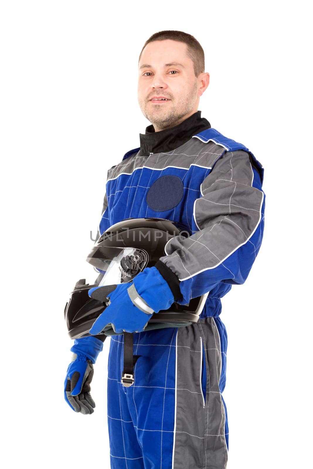 Racing driver posing with helmet isolated in white