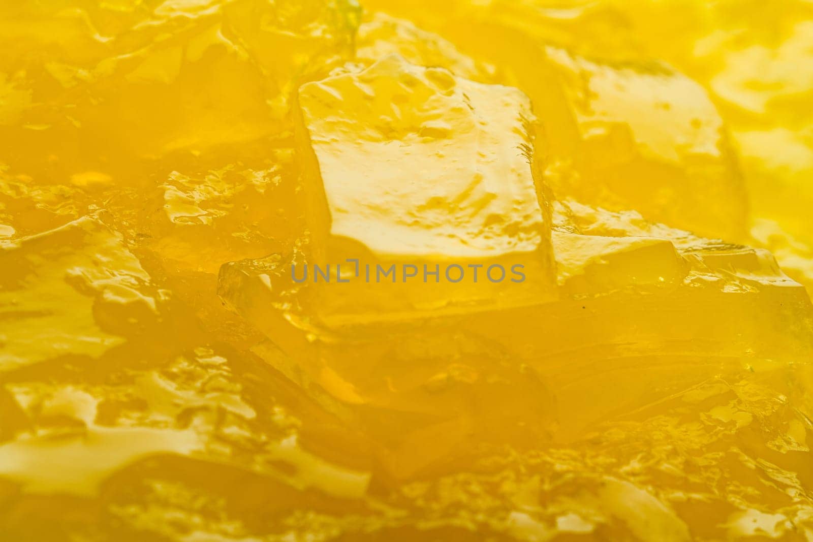Horizontal close up of yellow jelly background texture