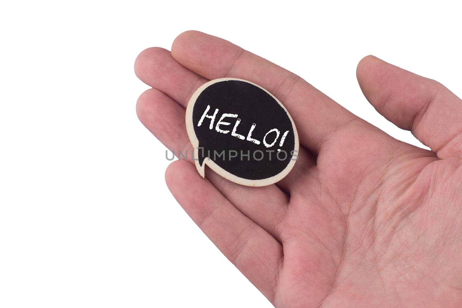 hand holding a wooden black speech bubble with hello text on it isolated on white