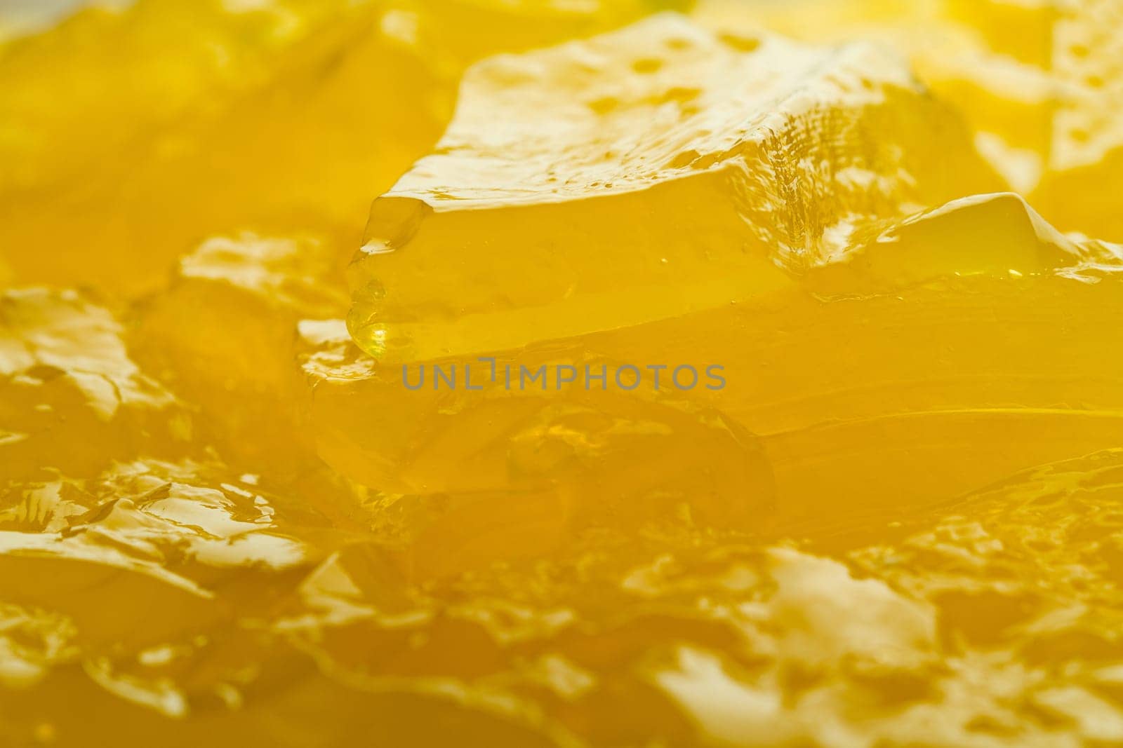Horizontal close up of yellow jelly background texture