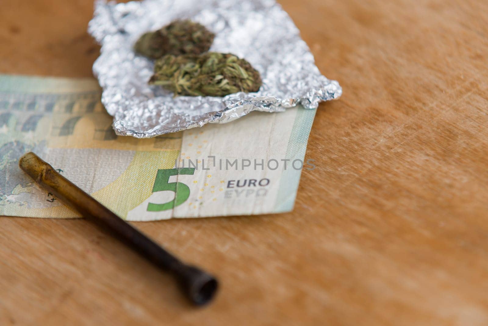 close up of marijuana,pipe and money