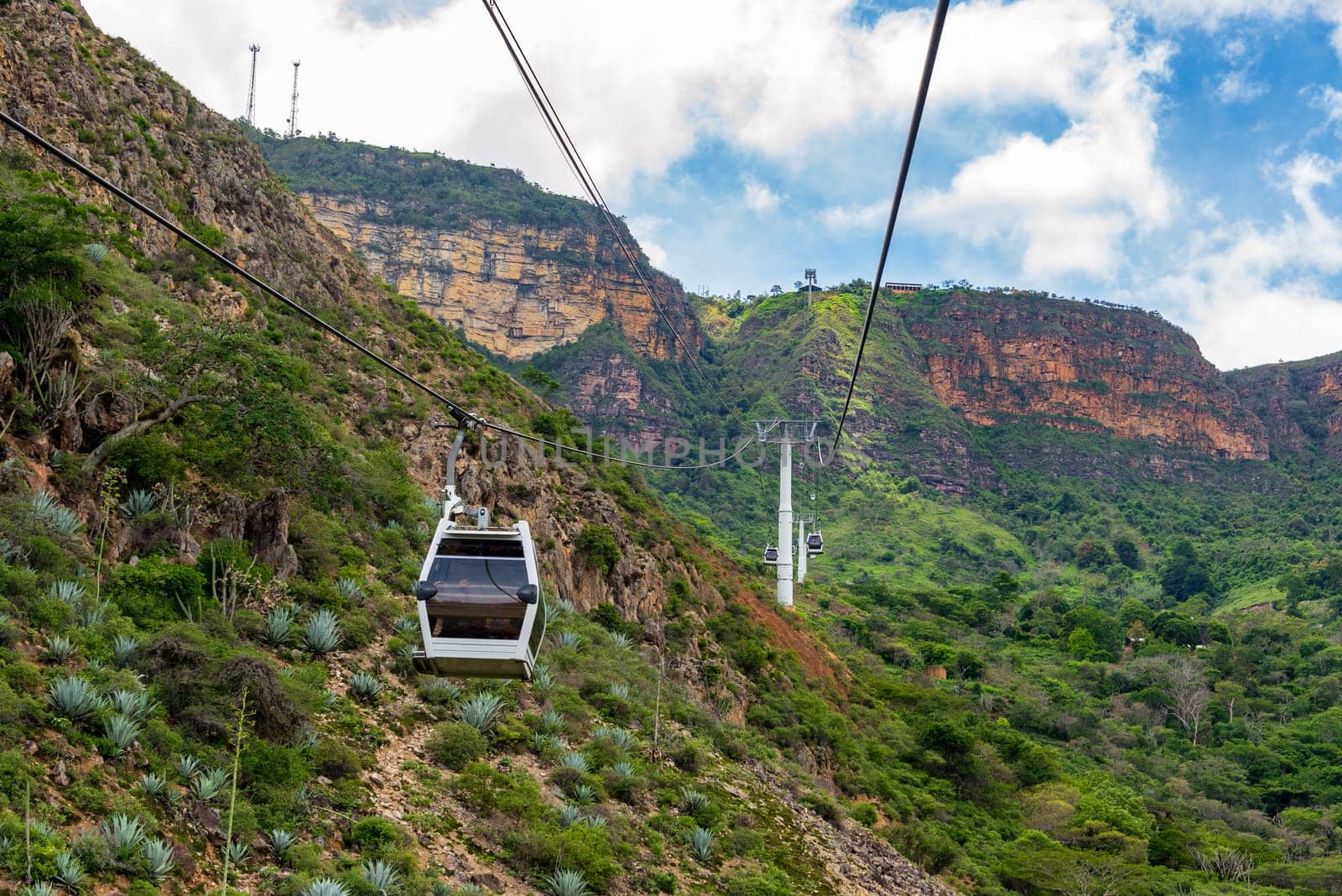 Rugged landscape view of an aerial tram rising up a cliff through Chicamocha Canyon in Santander, Colombia