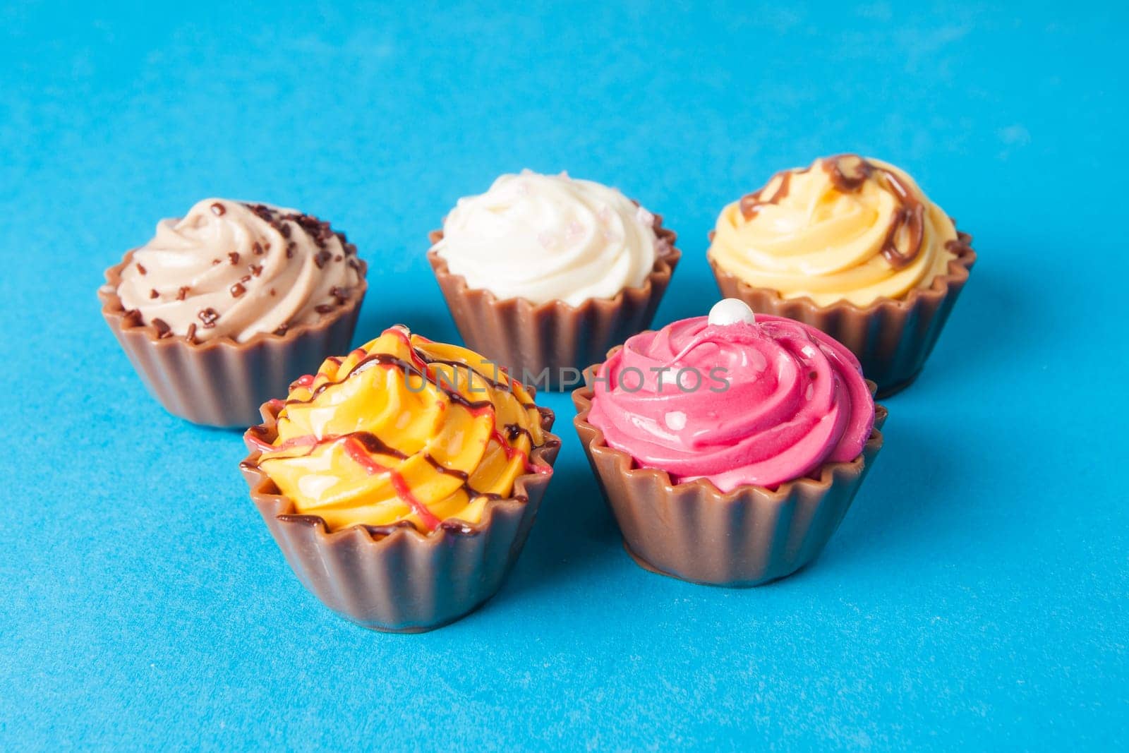 Birthday cupcakes on blue background. many sweet  cupcakes