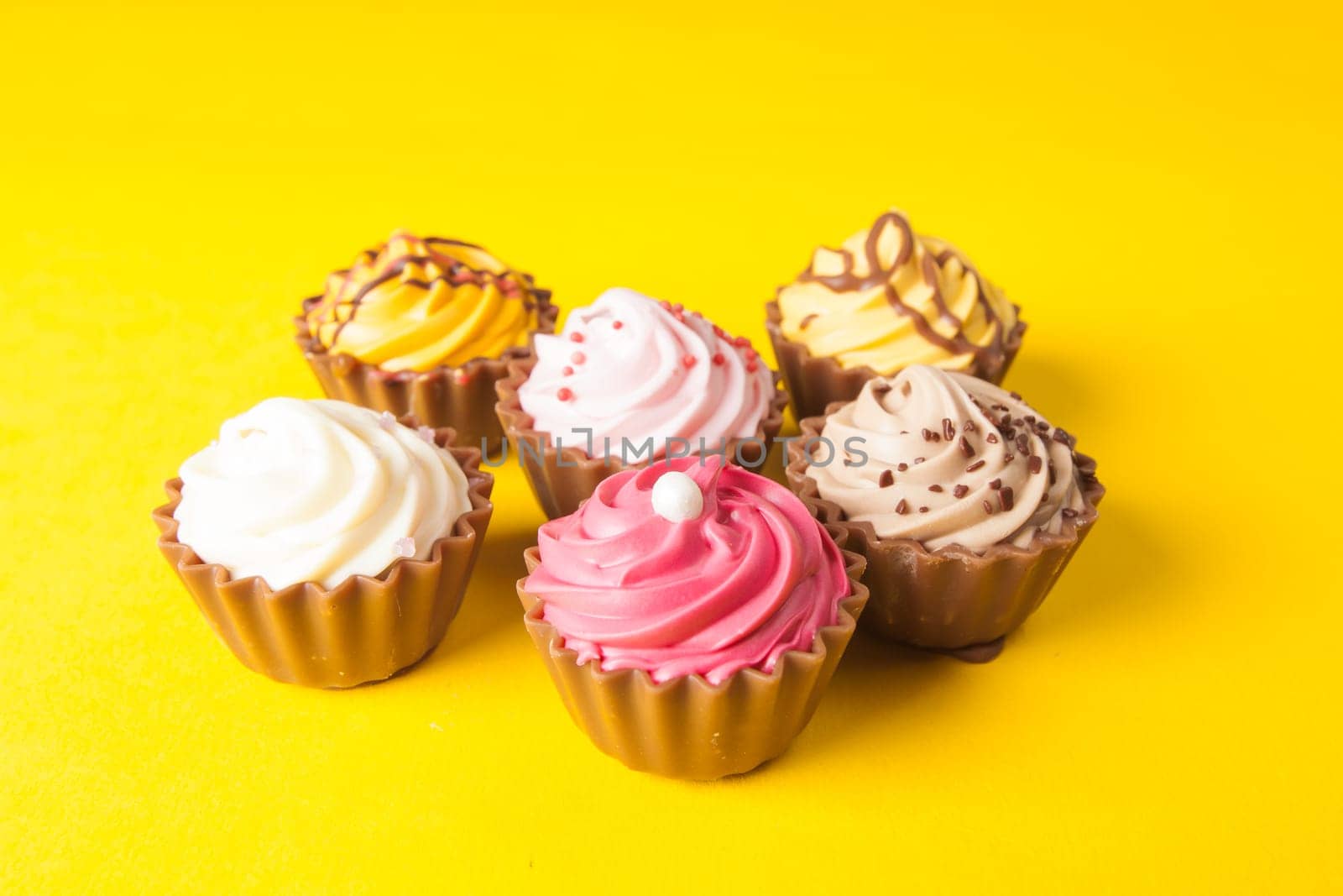 Chocolate cupcakes with yellow backgroud
