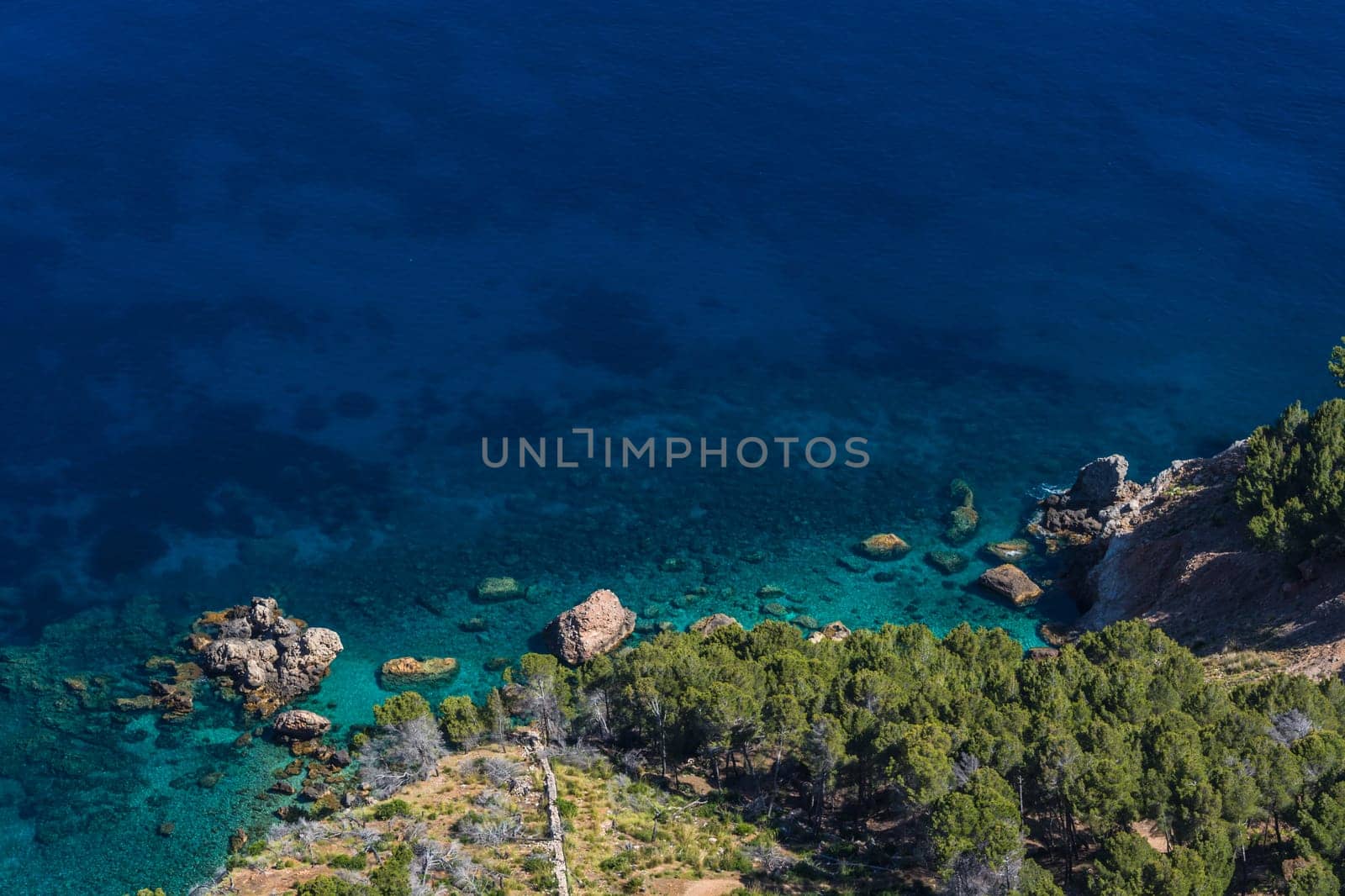Sea waves and rocks on the steep west coast of Mallorca. .