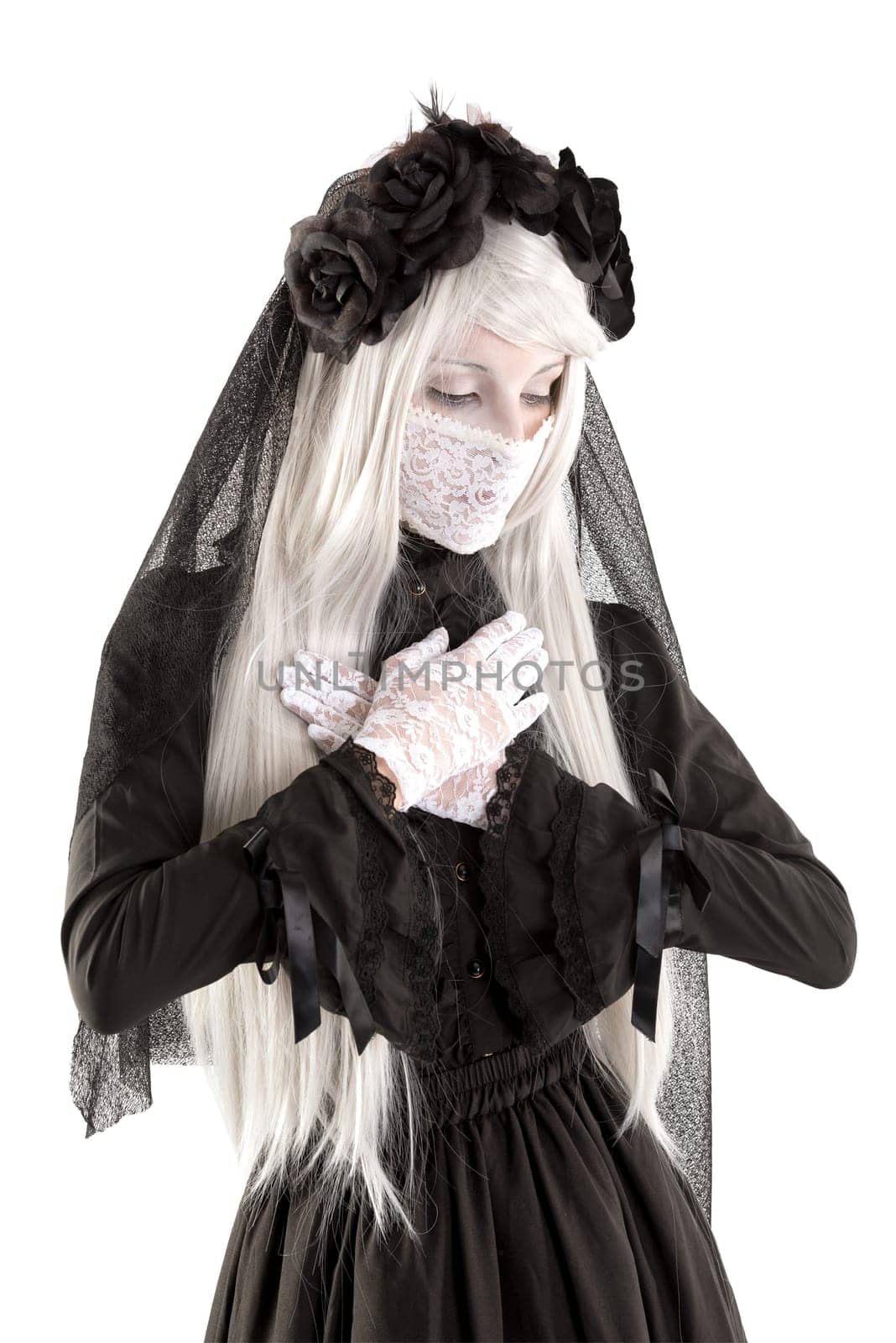 Widow in a black dress with white eyes looking like a doll isolated in white