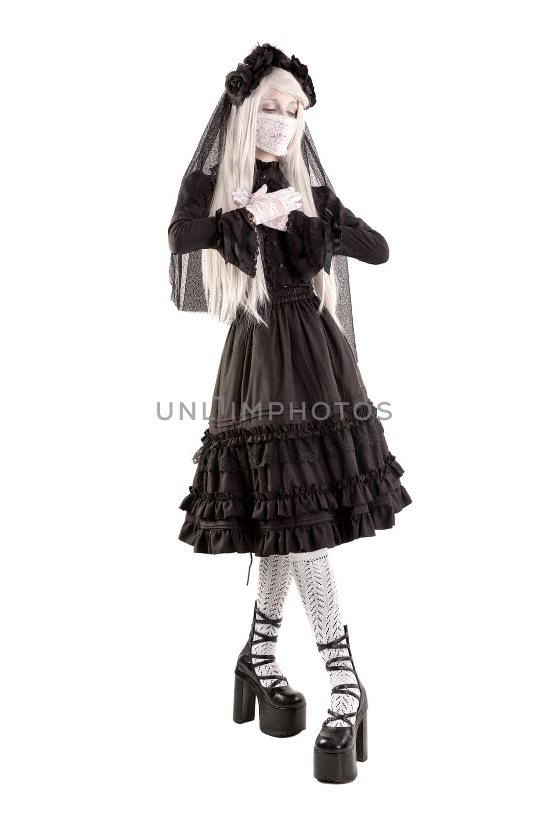 Widow in a black dress with white eyes looking like a doll isolated in white