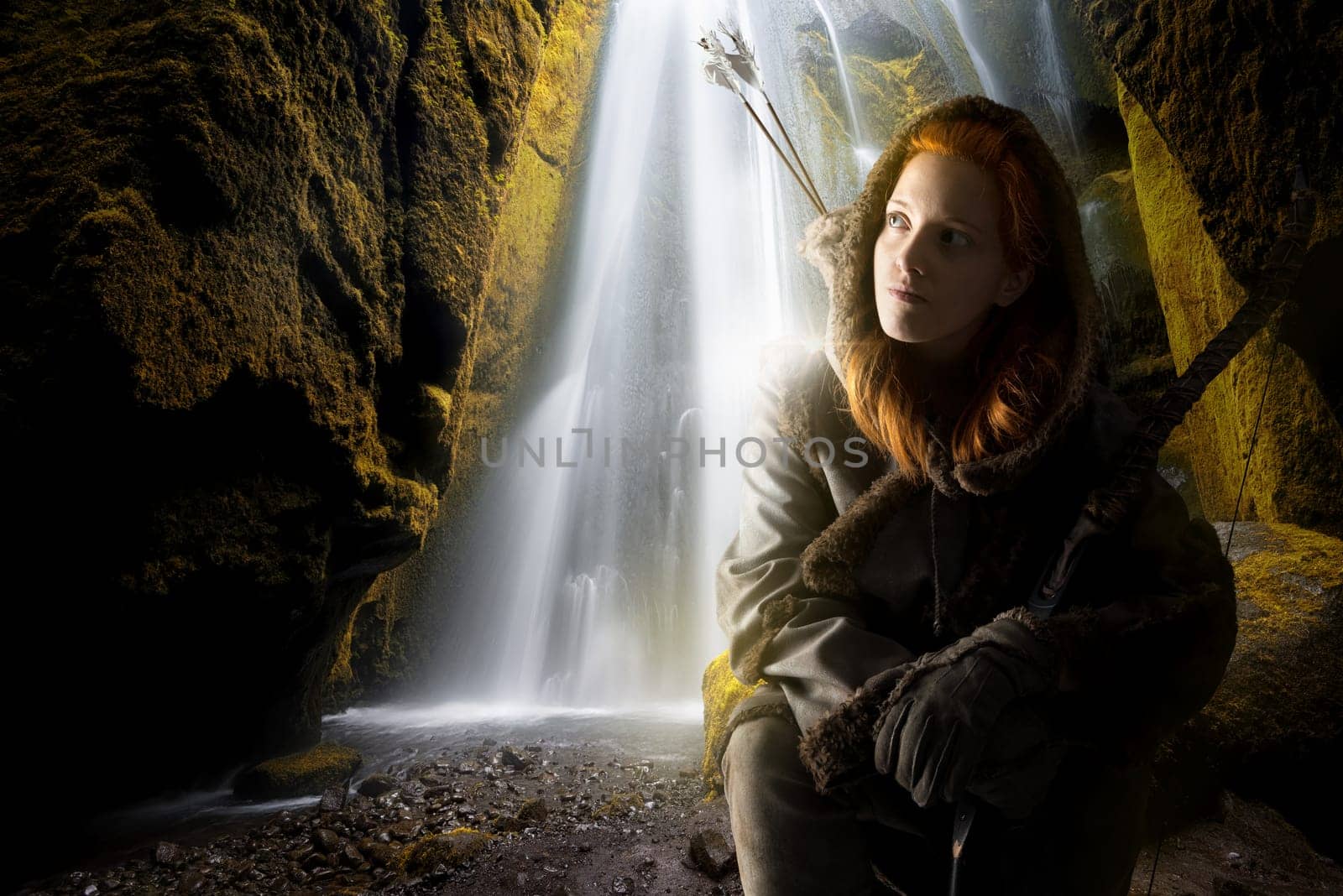 Fantasy girl archer in a waterfall with bow