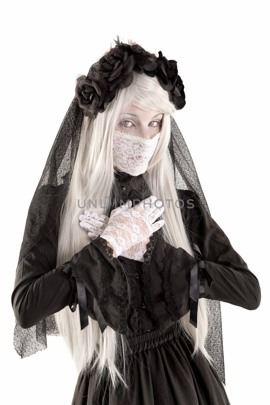 Widow in a black dress with white eyes looking like a doll isolated in white