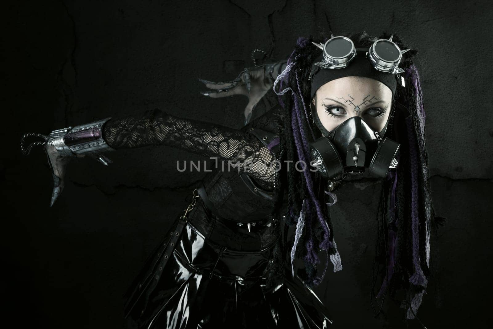 Cyber Gothic girl posing isolated in a dark background