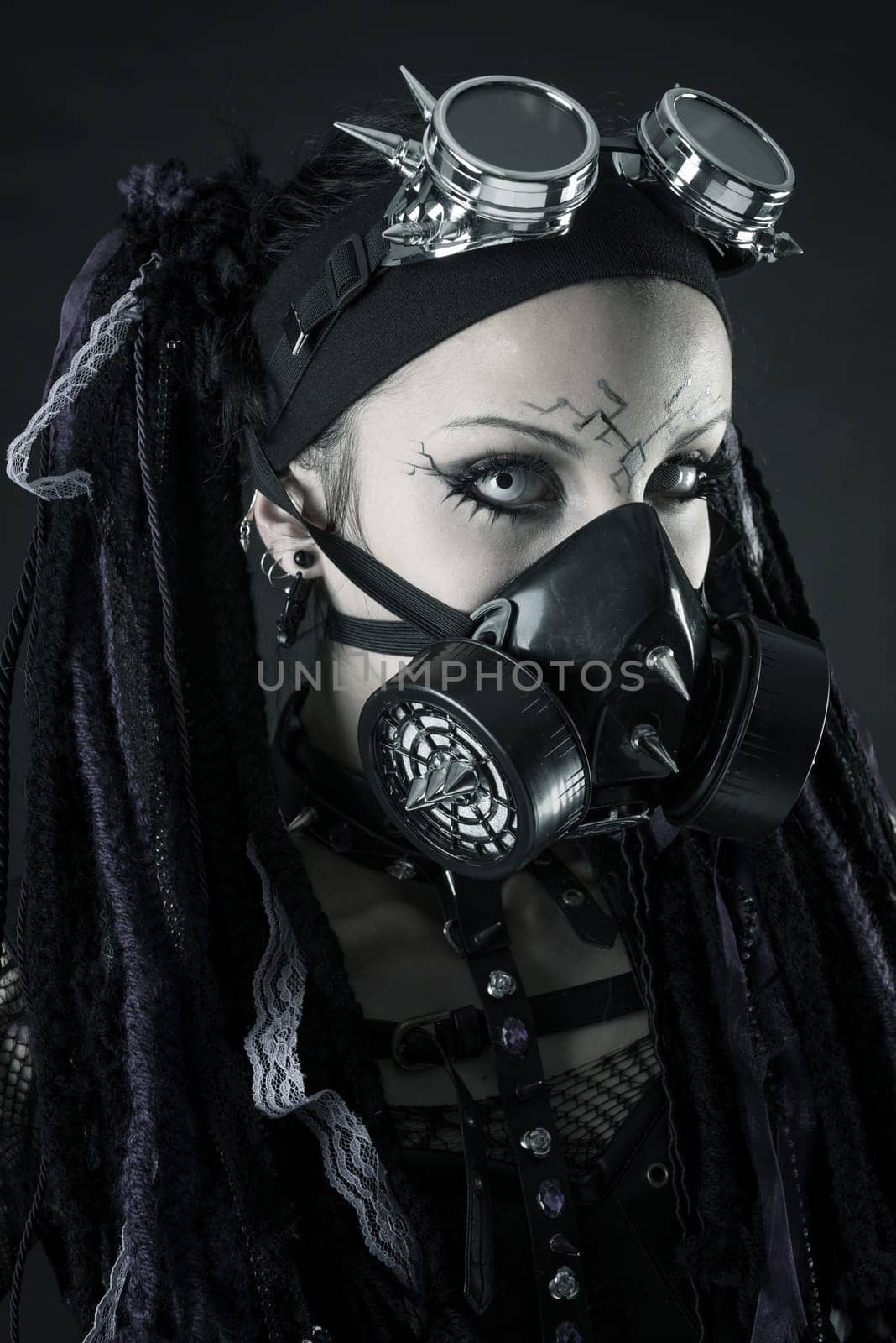 Cyber Gothic girl posing isolated in a dark background