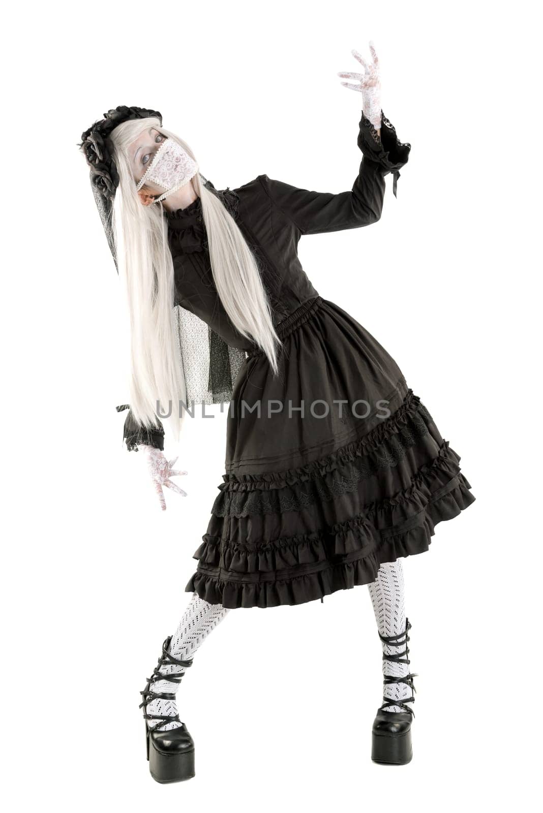 Widow in a black dress with white eyes looking like a doll isolated in white