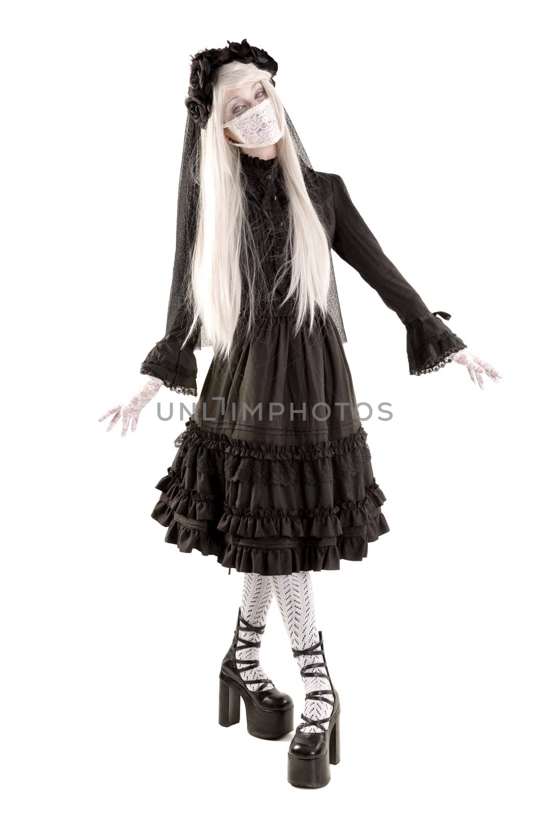 Widow in a black dress with white eyes looking like a doll isolated in white
