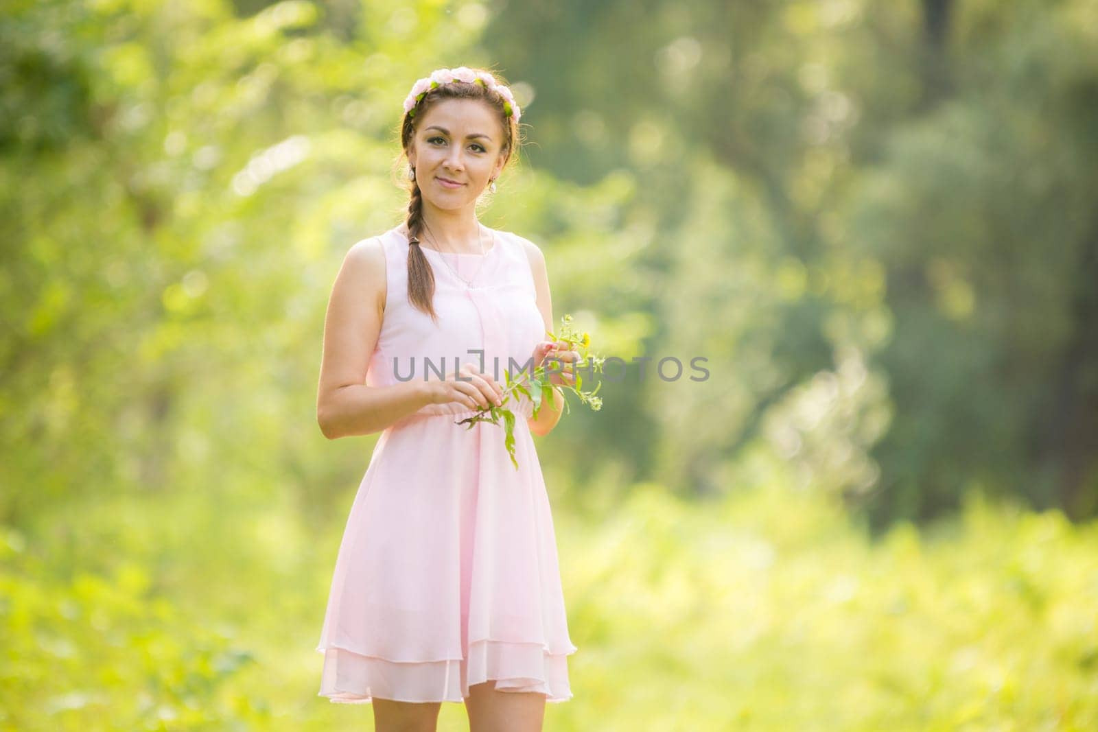 Portrait of a young girl picking flowers in a meadow