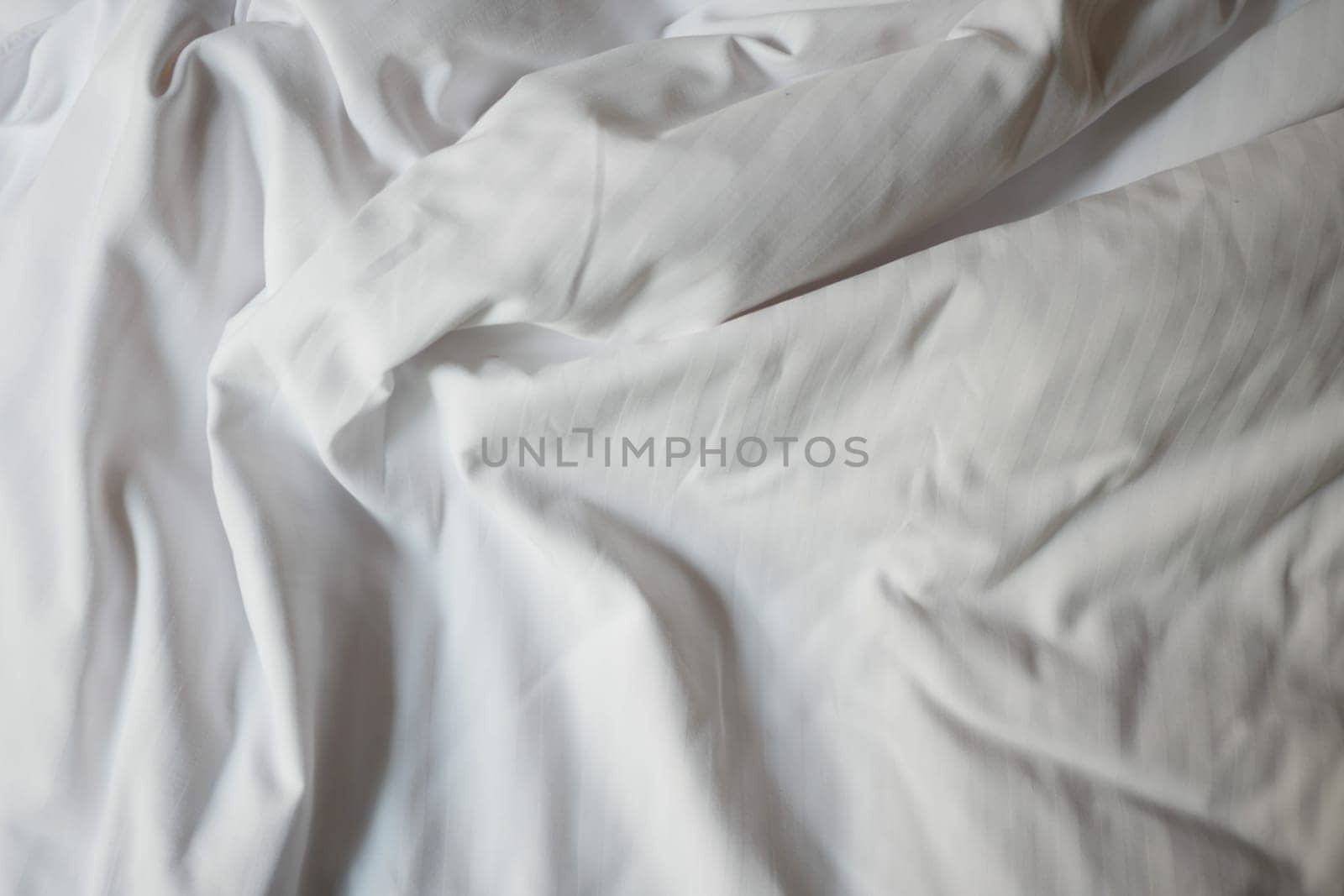 Gentle folds of white fabric create a serene and calming effect.