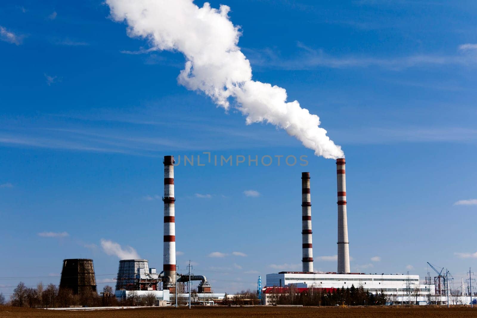 emissions from industrial plants against the blue sky.