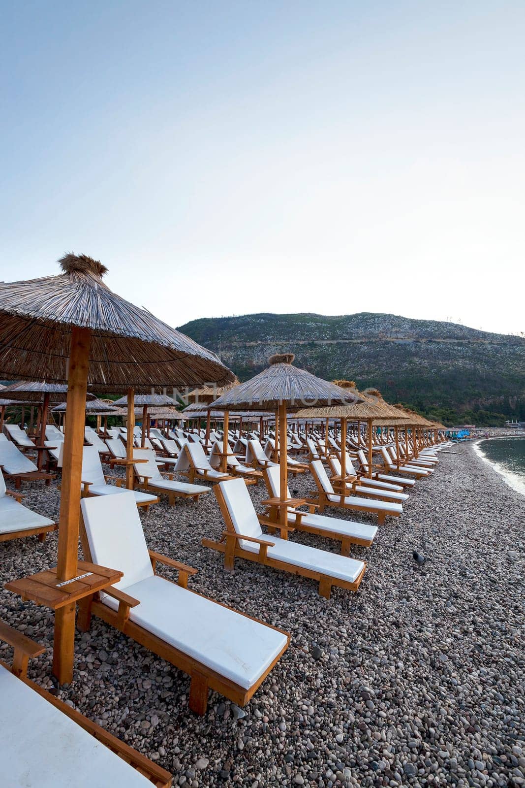 the wooden umbrellas located on a beach. Montenegro