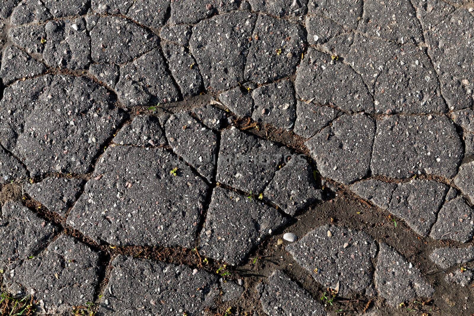 photographed close-up part of the road on which the broken cover - asphalt