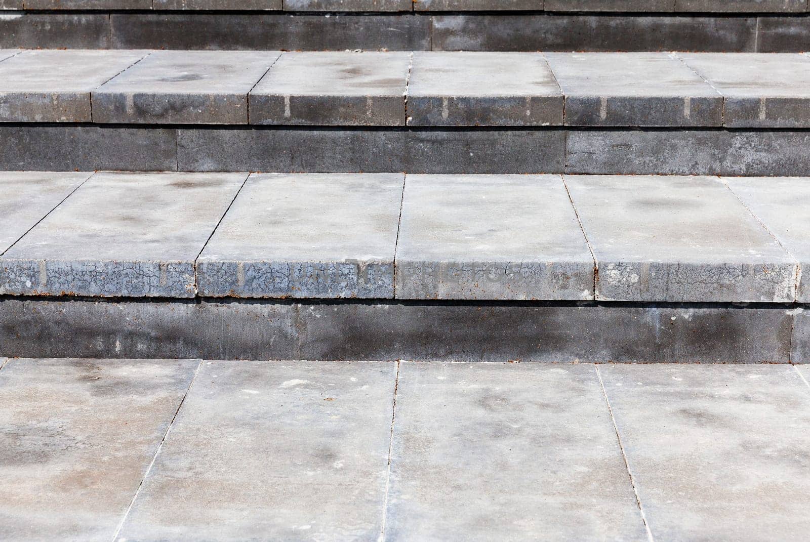 Photo broad steps made of concrete. Color gray structure, photographed at an angle and are visible plate