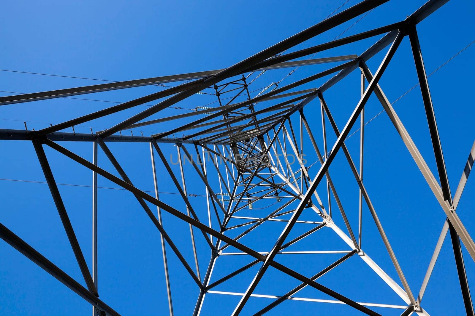 photographed close-up, high-voltage electric poles located in the countryside